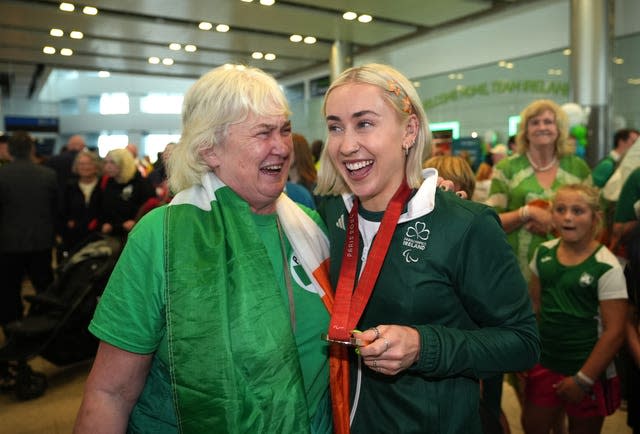 Ireland’s Orla Comerford, with Connie Corcoran (left), hug at the homecoming at Dublin Airport 