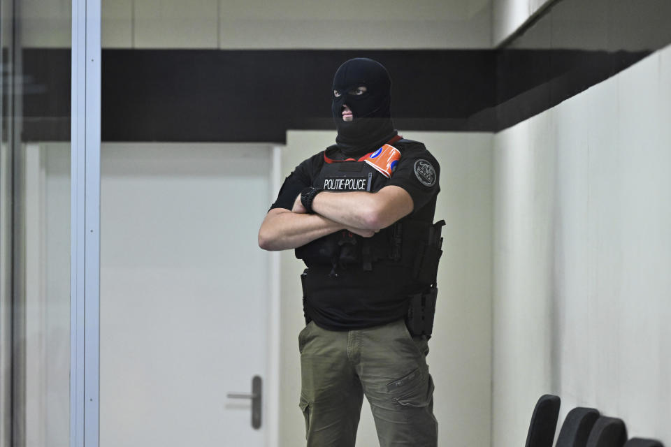 A police officer stands guard in the box prior to the reading of the sentences during the trial regarding the attacks at a Brussels metro station and the city's airport at the Justitia building in Brussels, Friday, Sept. 15, 2023. The morning rush hour attacks at Belgium's main airport and on the central commuter line took place on March 22, 2016, which killed 32 people, and nearly 900 others were wounded or suffered mental trauma. (John Thys, Pool Photo via AP)