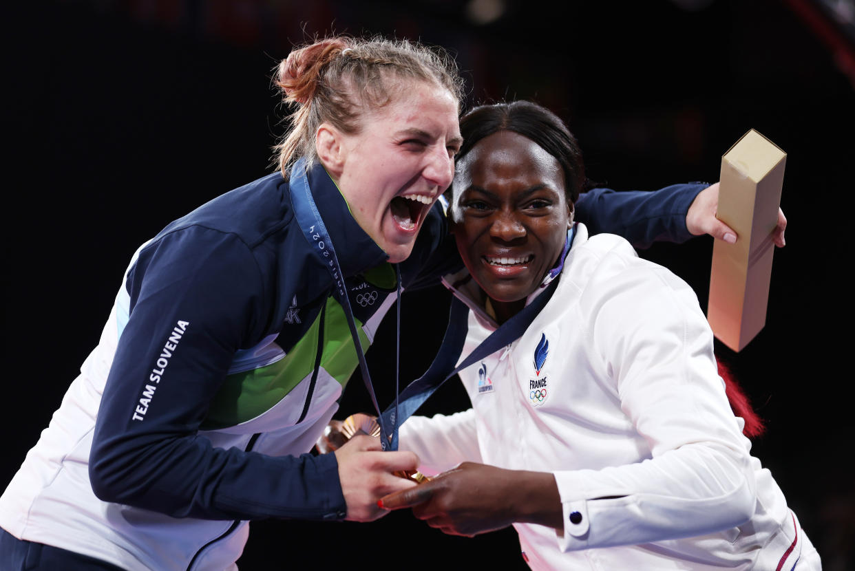 PARIS, FRANCE - JULY 30: Gold medalist Andreja Leski of Team Slovenia (L) celebrates with bronze medalist Clarisse Agbegnenou of Team France during the Women's Judo Women -63 kg medal ceremony on day four of the Olympic Games Paris 2024 at Champs-de-Mars Arena on July 30, 2024 in Paris, France. (Photo by Steph Chambers/Getty Images)