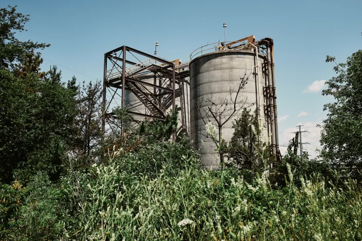 Silos of ash and other waste at the Brayton Point Power Station, a retired coal-fired power plant in Somerset, Mass., on July 7, 2022. (Simon Simard/The New York Times)