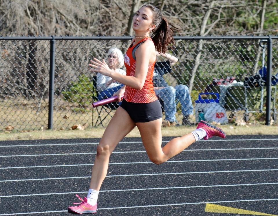 Harbor Springs' Claire Ranney runs a leg of the 4x200 meter relay event Friday, which the host Rams earned a runner-up finish in.