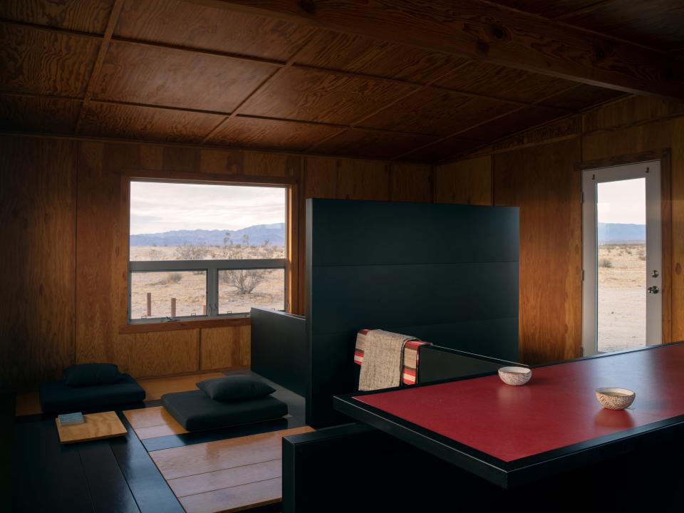 The interior of the “Experimental Living Cabin” in the Wonder Valley. Zittel’s “Planar Configuration One” defines the space. Aside from pots and pans for cooking, rustic “A-Z West Containers” are the only vessels.