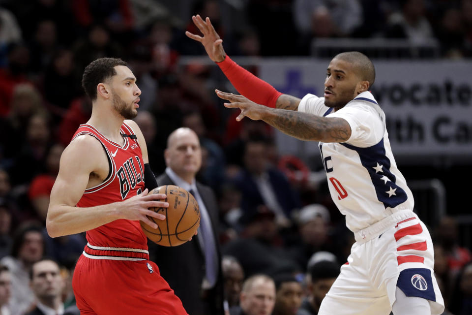 Chicago Bulls guard Zach LaVine, left, looks to pass the ball as Washington Wizards guard Gary Payton II defneds during the first half of an NBA basketball game in Chicago, Wednesday, Jan. 15, 2020. (AP Photo/Nam Y. Huh)