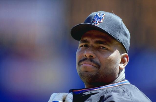 Bobby Bonilla watches as a fan with GREED written on his shirt, throws money  at him at the first game after …