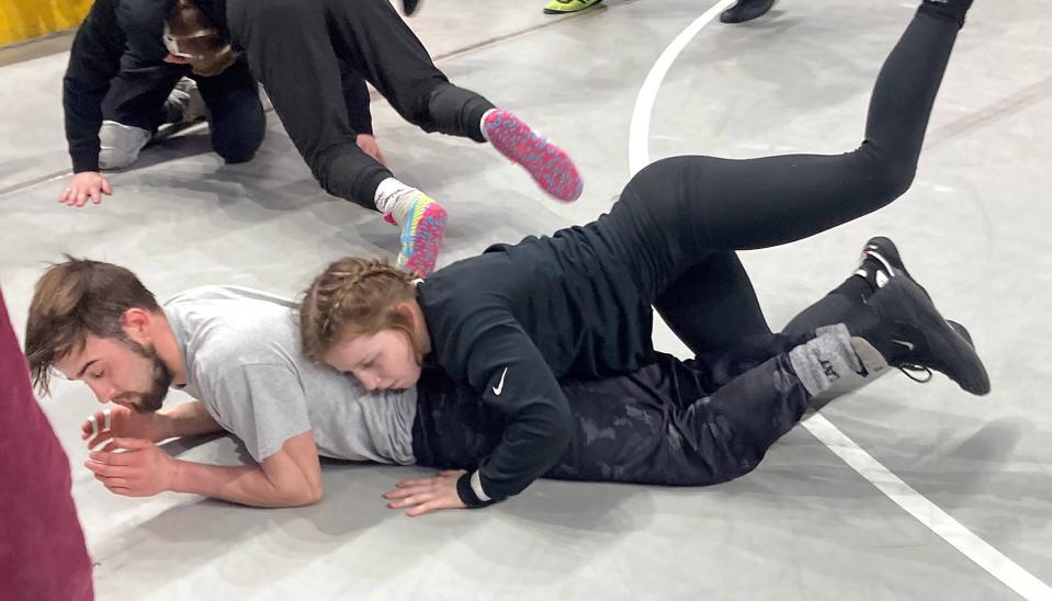 Northwestern's Sierra Chiesa, the first female to qualify for a PIAA wrestling tournament, spars with assistant coach Ben Tirpak during Wednesday's workout session at Hershey. Chiesa will compete in the Class 2A 107-pound division.