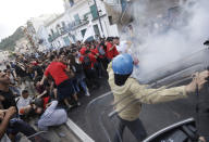 FILE - In this May 27, 2017, file photo demonstrators back up after a short contact with police during an anti-G7 rally near the venue of the G-7 summit in the Sicilian town of Taormina, Italy. For the 45th year in a row, seven of the most powerful people in the world will get together for an informal summit that has weathered everything from the Cold War through the global financial crisis to U.S. President Donald Trump’s Twitter feed. (AP Photo/Gregorio Borgia, File)