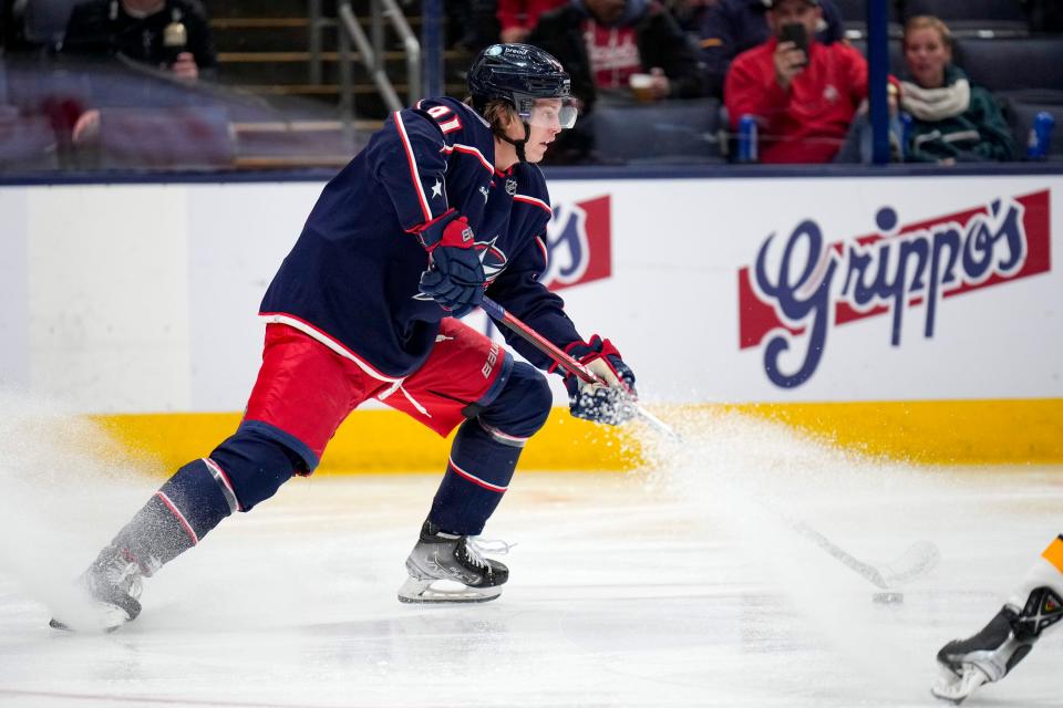 Oct 20, 2022; Columbus, Ohio, USA;  Columbus Blue Jackets forward Kent Johnson (91) kicks up ice while spinning around from Nashville Predators defense during the third period of the hockey game between the Columbus Blue Jackets and the Nashville Predators at Nationwide Arena. Mandatory Credit: Joseph Scheller-The Columbus Dispatch