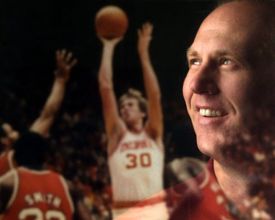 Ted Kitchel went from Indiana farm boy to an All-American. This portrait was taken in 2002 inside Kitchel's home. It is his reflection in a framed photograph of him playing against Ohio State during the championship season.