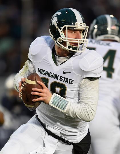 STATE COLLEGE, PA - NOVEMBER 29: Connor Cook #18 of the Michigan State Spartans looks to pass during the second quarter against the Penn State Nittany Lions at Beaver Stadium on November 29, 2014 in State College, Pennsylvania. (Photo by Joe Sargent/Getty Images)