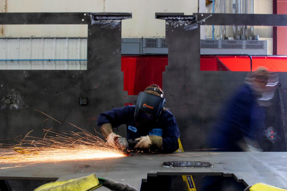 Magdalene Fett, 17, grinds down a weld on Aug. 22, 2022, at Renco Machine Inc., in Green Bay, Wis. Fett is a part of the Wisconsin Apprenticeship Program.