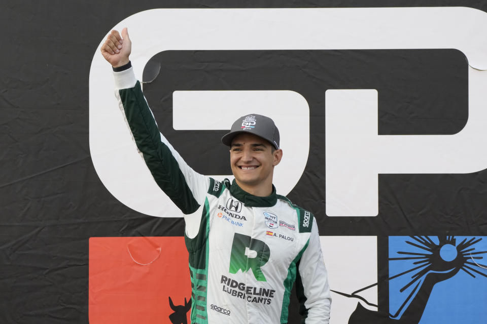 Alex Palou acknowledges fans after winning the IndyCar Detroit Grand Prix auto race, Sunday, June 4, 2023, in Detroit. (AP Photo/Carlos Osorio)