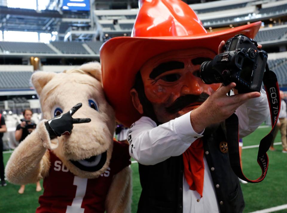 OU and OSU mascots Boomer, left, and Pistol Pete will not be seeing each other often in the near future.