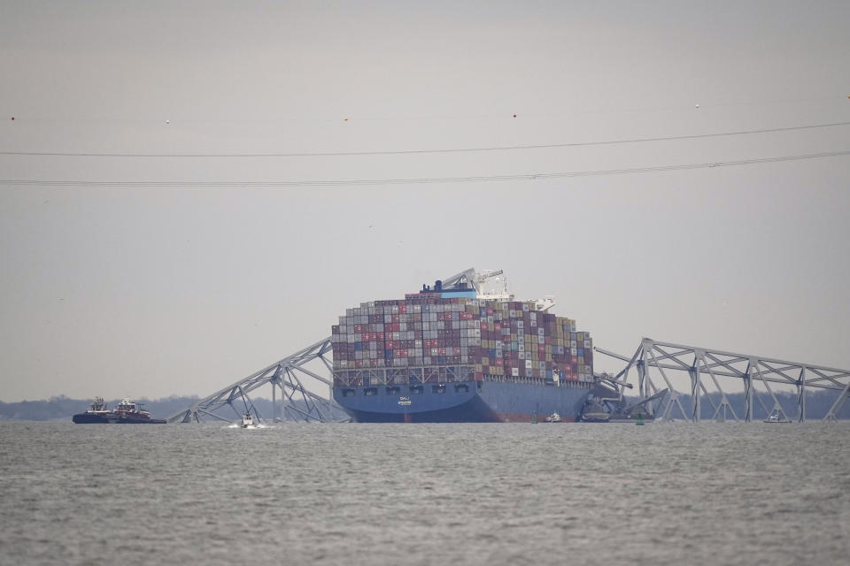 A container ship rests against the wreckage of the Francis Scott Key Bridge on Thursday, March 28, 2024, in Baltimore, Md. The ship rammed into the major bridge in Baltimore early Tuesday, causing it to collapse in a matter of seconds and creating a terrifying scene as several vehicles plunged into the chilly river below. (AP Photo/Matt Rourke)