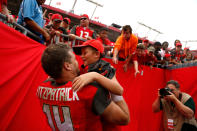 <p>Quarterback Ryan Fitzpatrick #14 of the Tampa Bay Buccaneers pulls on of his children out of the stands following the Buccaneers’ 15-10 win over the New York Jets at an NFL football game on November 12, 2017 at Raymond James Stadium in Tampa, Florida. (Photo by Brian Blanco/Getty Images) </p>