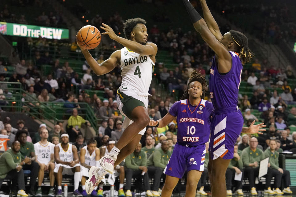 Baylor guard LJ Cryer (4) looks to pass against Northwestern State defenders Reggie Hill (1) and Greedy Williams (10) during the second half of an NCAA college basketball game in Waco, Texas, Tuesday, Dec. 20, 2022. Baylor won 58-48. (AP Photo/LM Otero)