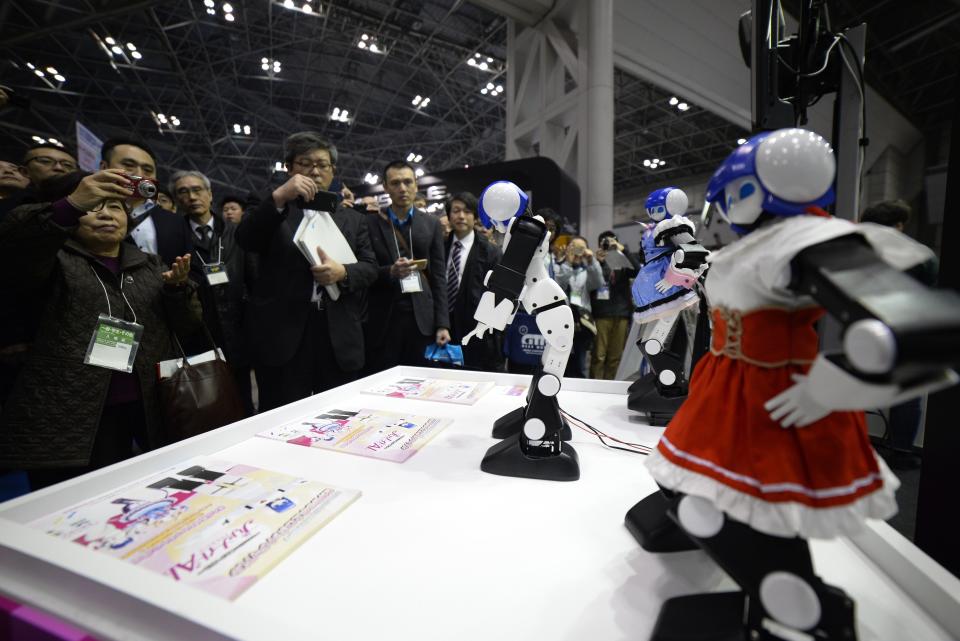 Small robots perform for exhibition attendees.