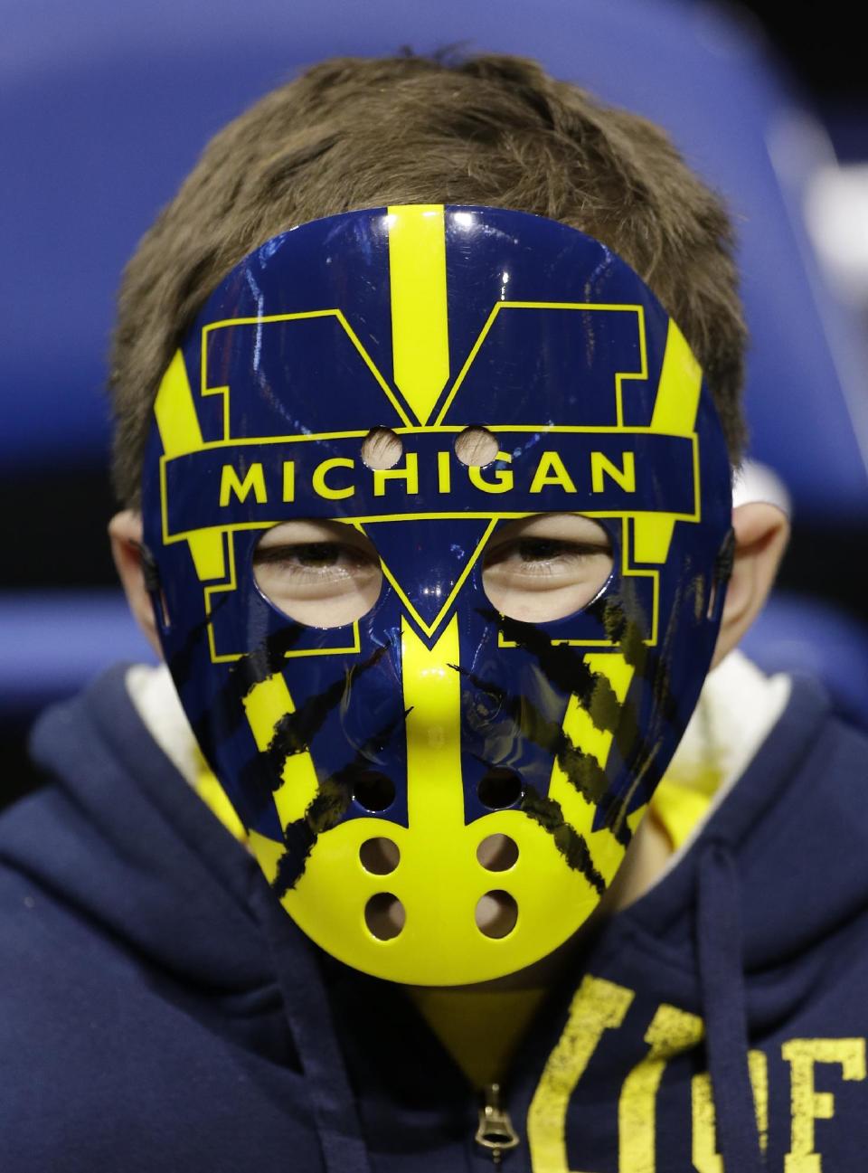 A Michigan fan gets ready for the start of an NCAA Midwest Regional semifinal college basketball tournament game against the Tennessee Friday, March 28, 2014, in Indianapolis. (AP Photo/David J. Phillip)