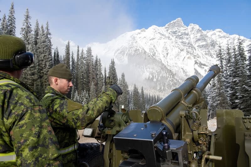 Gunners from Royal Canadian Artillery fire howitzer at snow pack at Rogers Pass