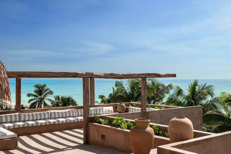 The rooftop at XELA Tulum with the ocean in the background