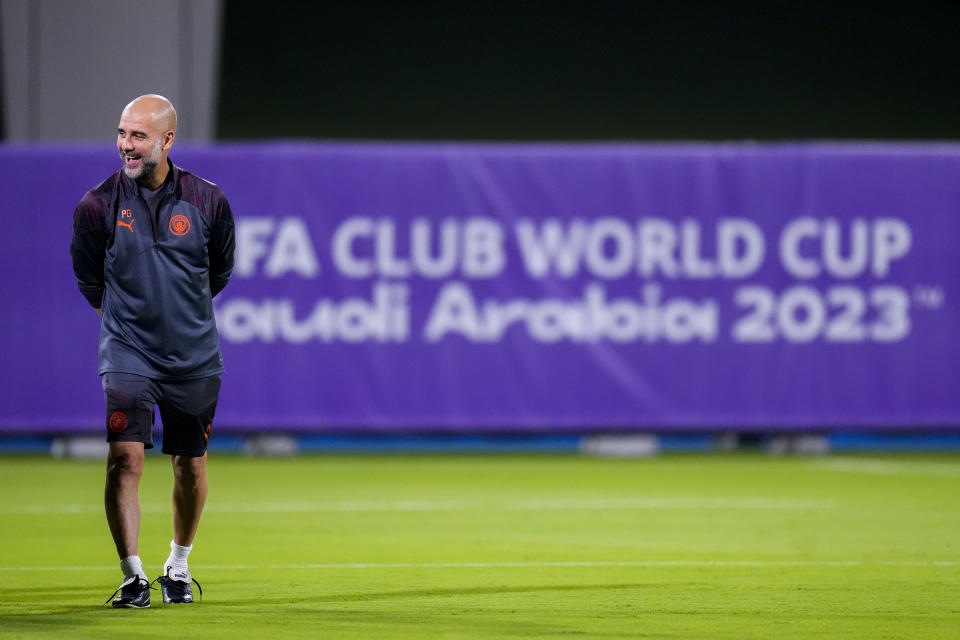 Manchester City's head coach Pep Guardiola laughs during a training session at the King Abdullah Sports City Stadium in Jeddah, Saudi Arabia, Monday, Dec. 18, 2023. Urawa Reds will play against Manchester City during the semifinal soccer match during the Club World Cup on Tuesday Dec. 19.(AP Photo/Manu Fernandez)