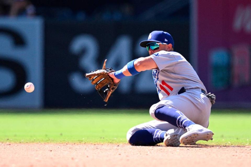 Aug 7, 2023; San Diego, California, USA; Los Angeles Dodgers shortstop Miguel Rojas (11) fields a ground ball against the San Diego Padres during the ninth inning at Petco Park.