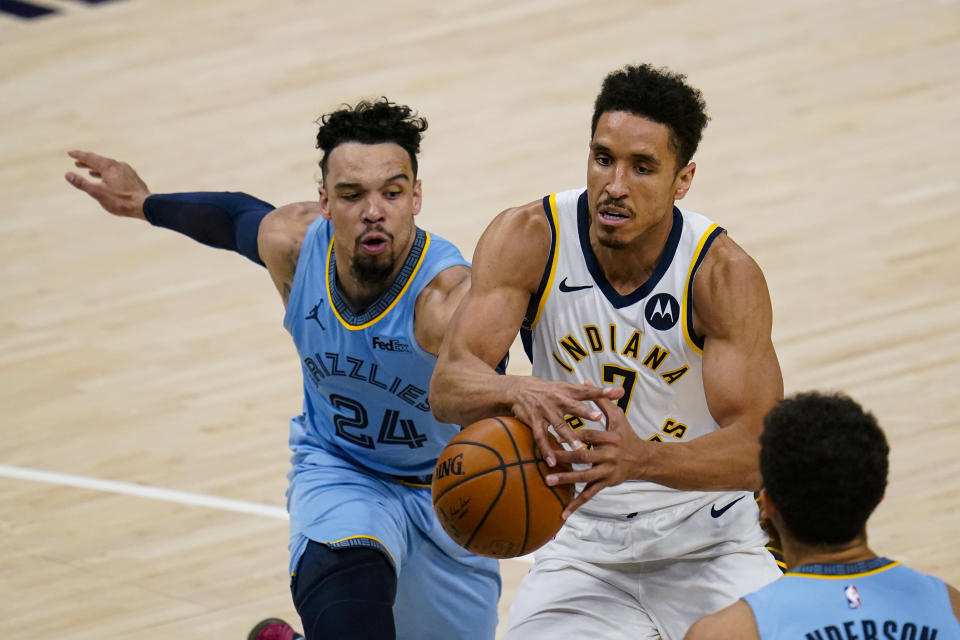 Memphis Grizzlies guard Dillon Brooks (24) knocks the ball away from Indiana Pacers guard Malcolm Brogdon (7) during the second half of an NBA basketball game in Indianapolis, Tuesday, Feb. 2, 2021. (AP Photo/Michael Conroy)