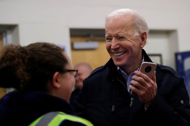 Democratic 2020 U.S. presidential candidate and former Vice President Joe Biden chats with school bus drivers during a visit at a bus garage while campaigning in Nashua, New Hampshire U.S.