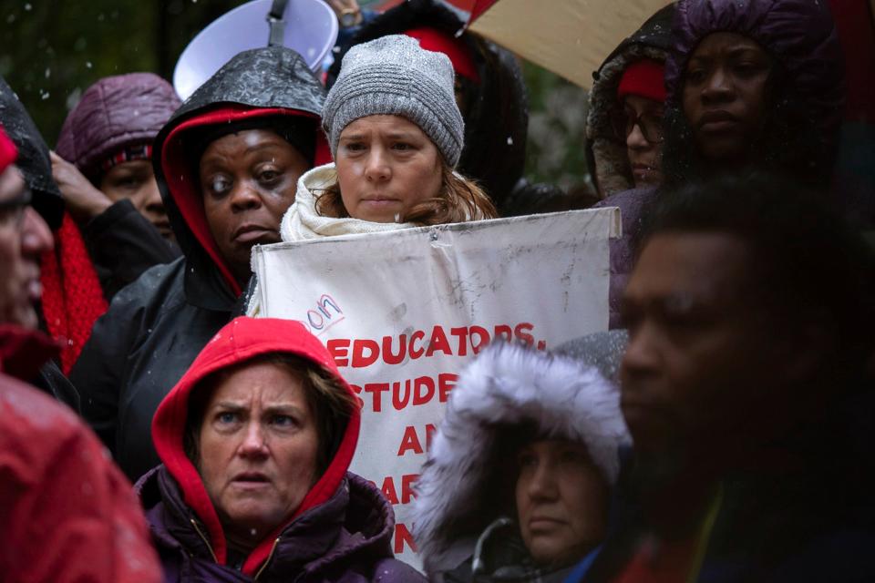 Teachers listen to Chicago Teachers Union President Jesse Sharkey as he updates them about negotiations during a rally outside the Thompson Center in Chicago, on Thursday, Oct. 31, 2019.