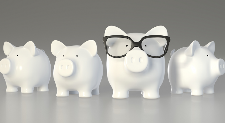 An image of four piggy banks, one with glasses on to represent smart money in investing