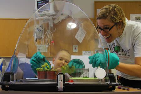 Science teacher Katie Stoudemire uses the WonderSphere with Harrison, a patient at the North Carolina Children’s Hospital in this undated handout photo. Photo courtesy of Alyssa LaFaro, UNC Research via REUTERS