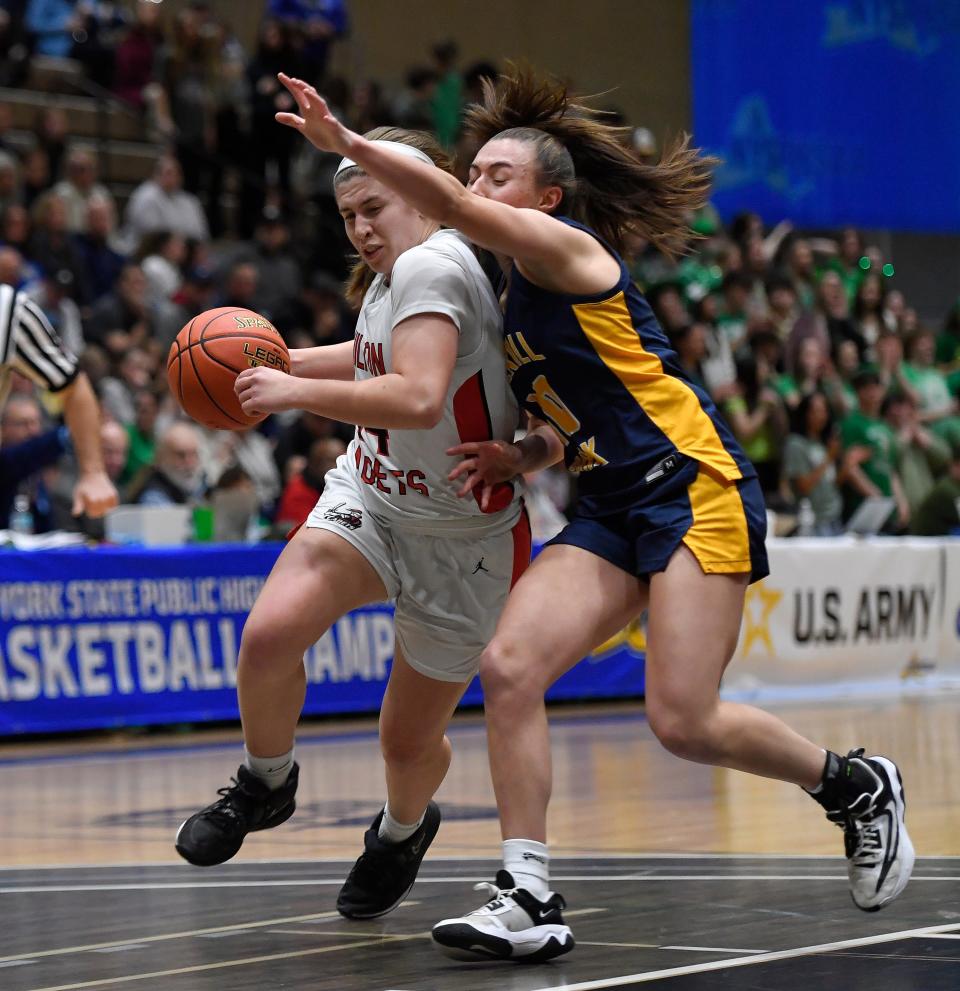 Hilton's Mallory Heise, left, drives to the basket against Averill Park's Arianna Verardi during a NYSPHSAA Class AA Girls Basketball Championships semifinal in Troy, N.Y., Friday, March 15, 2024. Hilton advanced to the Class AA final with a 73-71 overtime win against Averill Park-II.