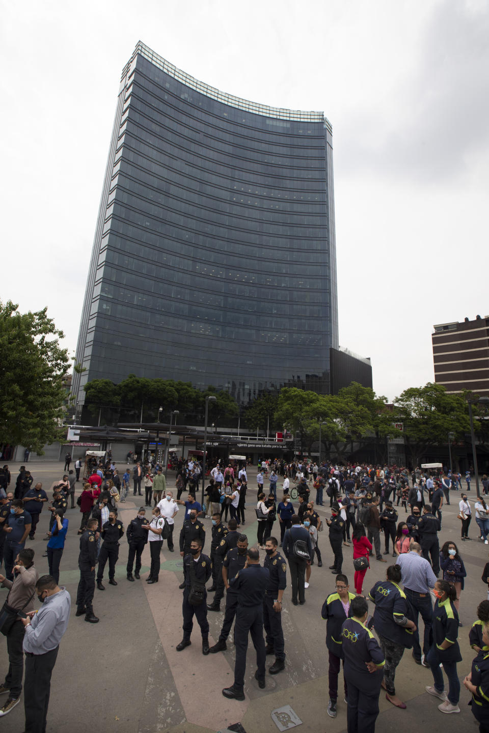 Residents stand in the pedestrian walkway of the Insurgentes roundabout after an earthquake in Mexico City on Tuesday, June 23, 2020. The earthquake struck near the Huatulco resort in southern Mexico on Tuesday morning, swayed buildings in Mexico City and sent thousands fleeing into the streets. (AP Photo/Marco Ugarte)