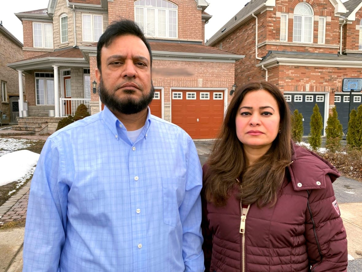 Kashif and Salma Siddiqui say the tenants in the downstairs apartment of their Mississauga investment home have stopped paying rent and refuse to leave, even after the home was sold. Now, the couple is bearing the costs of two homes while waiting for the case to be adjudicated at a backlogged Landlord and Tenant Board. (Ryan Patrick Jones/CBC  - image credit)