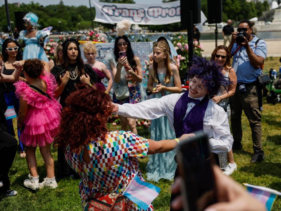 Simon Garbett, 17, who hails from Little Rock, Arkansas, dances with his mom Lizz Garbett during the "Trans Youth Prom" on May 22, 2023 in Washington, DC.