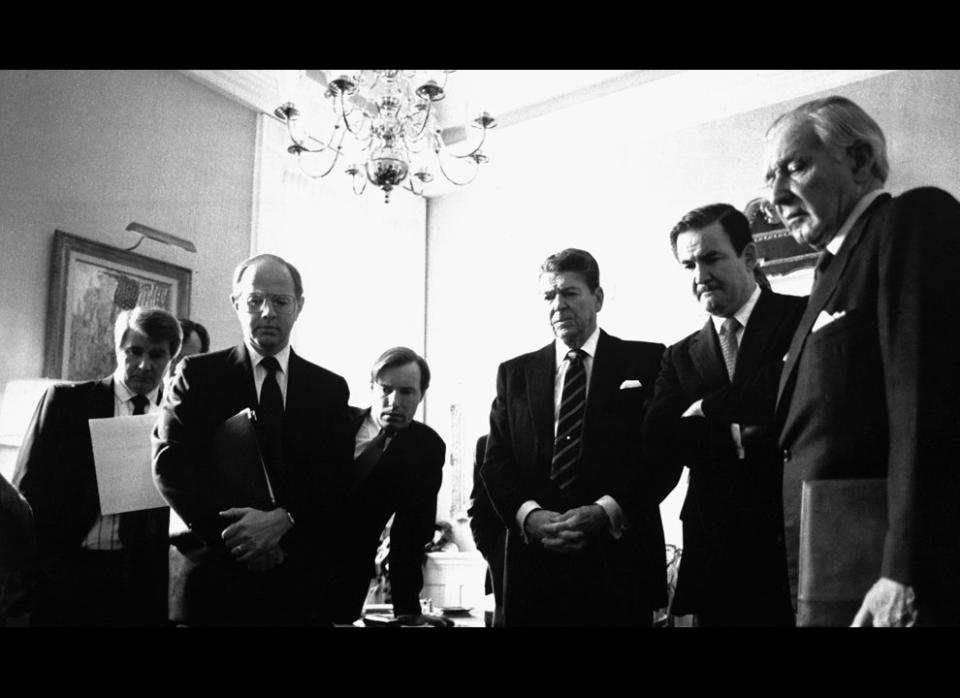Photograph of President Reagan and his staff watching a televised replay of the Space Shuttle "Challenger" explosion. (AP/ Craig Fuji, January 28, 1986) (<a href="http://history1900s.about.com/od/photographs/ig/Space-Shuttle-Challenger/" target="_hplink">Via About.com</a>)