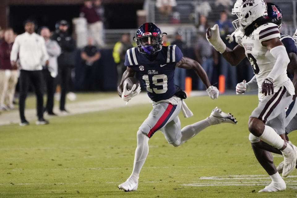 Mississippi wide receiver Dayton Wade (19) turns the corner with a pass reception, past Mississippi State's Decamerion Richardson during the first half of an NCAA college football game in Oxford, Miss., Thursday, Nov. 24, 2022. (AP Photo/Rogelio V. Solis)