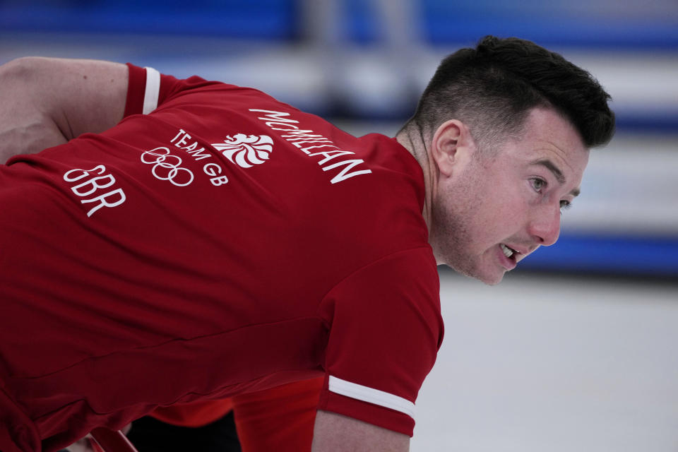 Britain's Hammy Mcmillan, sweeps the ice, during the men's curling match against Italy, at the 2022 Winter Olympics, Thursday, Feb. 10, 2022, in Beijing. (AP Photo/Nariman El-Mofty)