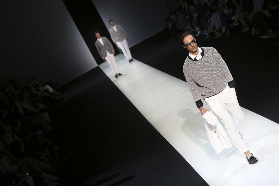 Models wear creations for Giorgio Armani men's Spring-Summer 2014 collection, part of the Milan Fashion Week, unveiled in Milan, Italy, Tuesday, June 25, 2013. (AP Photo/Luca Bruno)