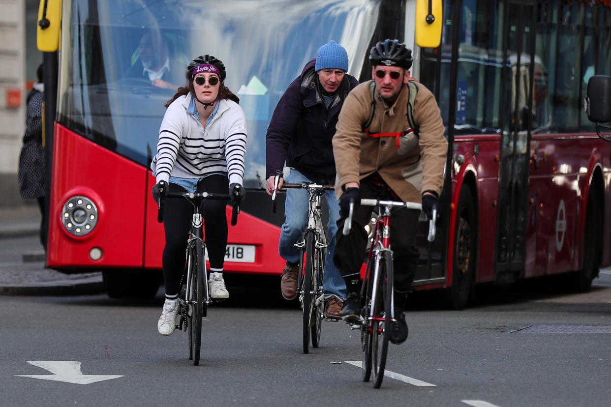 Cyclists take to the middle of the road and ride two-abreast in the street, as the new Highway Code rules start today together with giving pedestrians priority at junctions, at the junction of Trafalgar Square, in London, Britain, January 29, 2022. REUTERS/May James