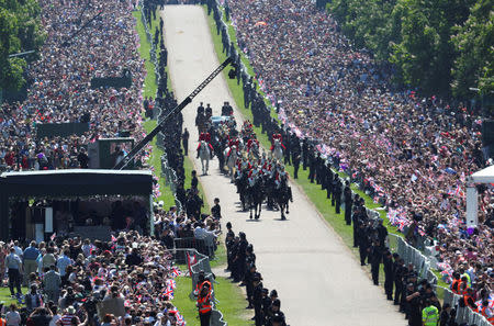 FILE PHOTO: Britain's Prince Harry and his wife Meghan Markle ride a horse-drawn carriage along the Long Walk, after their wedding ceremony at St George's Chapel in Windsor, Britain, May 19, 2018. REUTERS/Hannah McKay/File Photo