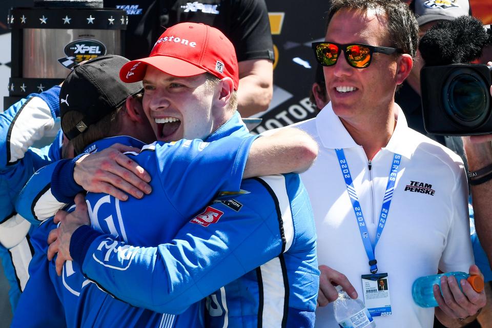 Josef Newgarden embraces a crew member after winning an IndyCar Series auto race at Texas Motor Speedway in Fort Worth, Texas, Sunday, March 20, 2022.