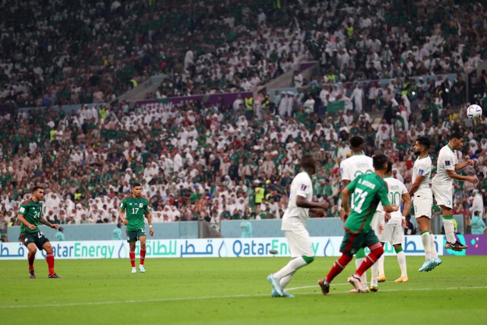 LUSAIL CITY, QATAR - NOVEMBER 30: Luis Chavez of Mexico scores their team's second goal from a free kick during the FIFA World Cup Qatar 2022 Group C match between Saudi Arabia and Mexico at Lusail Stadium on November 30, 2022 in Lusail City, Qatar. (Photo by Michael Steele/Getty Images)