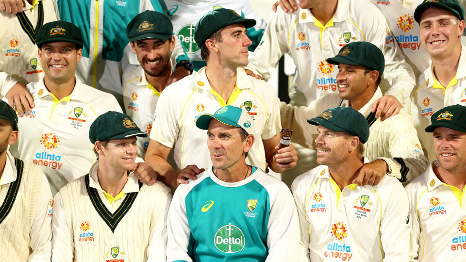 Pictured bottom centre is Australia cricket coach Justin Langer surrounded by his players.