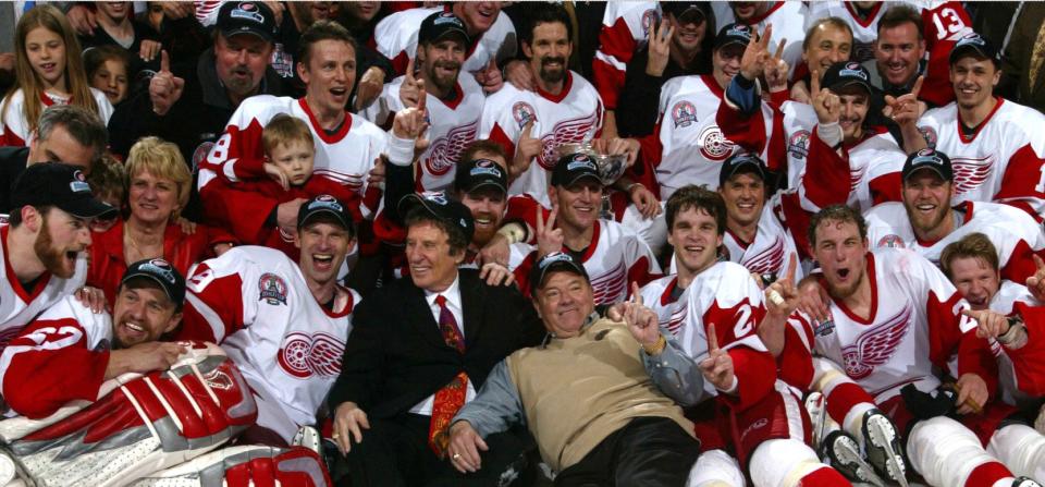 Detroit Red Wings celebrate on the ice after winning the Stanley Cup on June 13, 2002 at Joe Louis Arena over the Carolina Hurricanes. Mike Ilitch, Marian Ilitch and Scotty Bowman are in the picture along with the team.