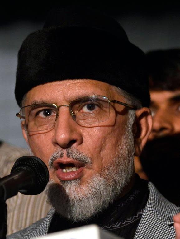 Canada-based preacher Tahir-ul-Qadri speaks with media outside his residence in Lahore, on August 13, 2014