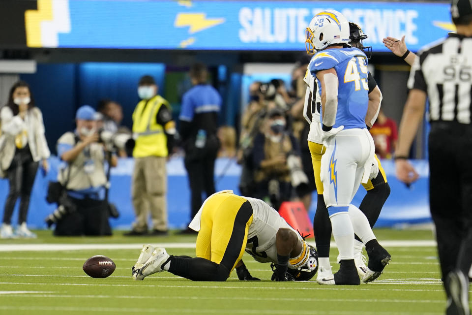 Pittsburgh Steelers running back Najee Harris, center, stays down after an injury during the second half of an NFL football game against the Los Angeles Chargers, Sunday, Nov. 21, 2021, in Inglewood, Calif. (AP Photo/Marcio Jose Sanchez)