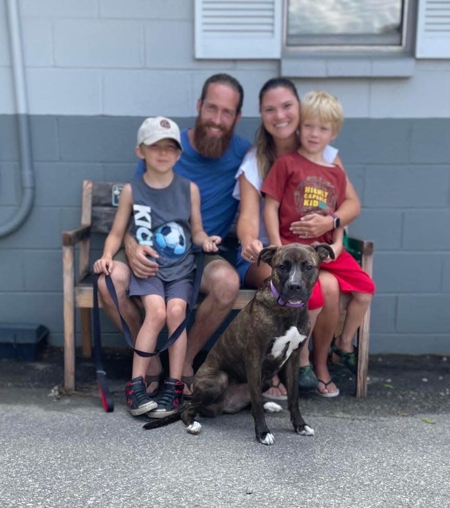 Amanda Crew, her husband Nate, and their two boys, Jackson and Willy, pose with Rhubarb at the Fayetteville Animal Protection Society.