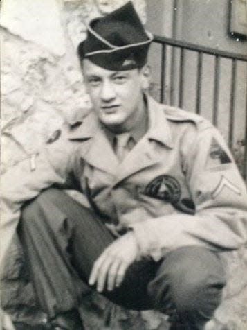 Harry F. Miller, a member of the 740th Tank Battalion of the U.S. Army , poses in his military uniform during deployment in World War II.