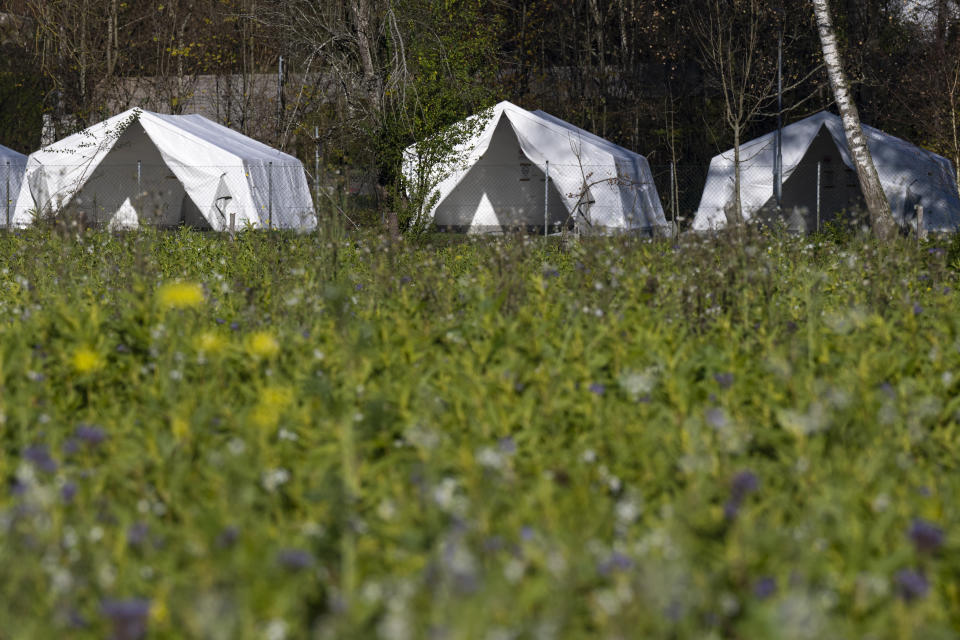 Tents setup as a shelter for refugees stand on a meadow in St. Georgen im Attergau, Austria, Monday, Nov. 14, 2022. In a weeks-long standoff with the Austrian government over the accommodation of rising numbers of asylum seekers in the alpine country, the mayor of the small village St. Georgen defied national housing measures and ordered the dismantling of more than a dozen tents for some 100 migrants in his community citing security concerns. (AP Photo/Andreas Schaad)