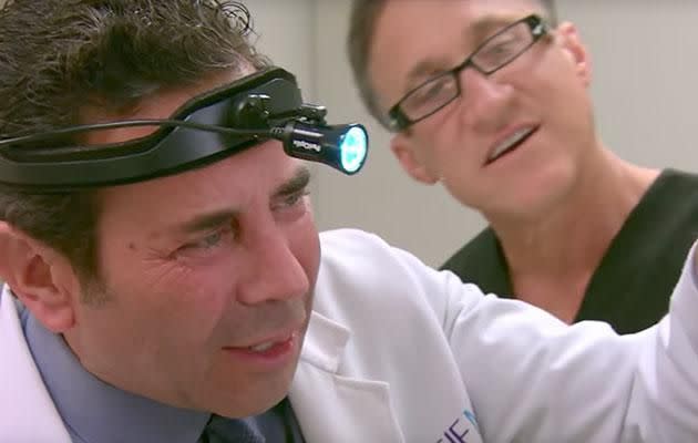 Dr Nassif is seen trying to exam the model's nose in an episode of 'Botched'. Photo: Youtube/E! Entertainment